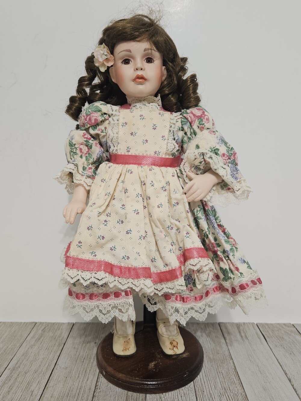 Vintage Porcelain 15" Doll with Floral Dress and Brown Curly Hair and Wooden Bas